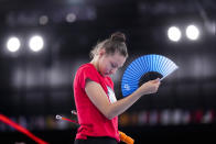 Evita Griskenas from the United States uses a hand fan during a break of her individual rhythmic gymnastics training session at the 2020 Summer Olympics, Thursday, Aug. 5, 2021, in Tokyo, Japan. (AP Photo/Markus Schreiber)