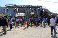 <p>People gather at site after a bomb-laden vehicle attacked a marketplace in Moghadishu, Somalia on Feb. 19, 2017. (Photo: Sadak Mohamed/Anadolu Agency/Getty Images) </p>