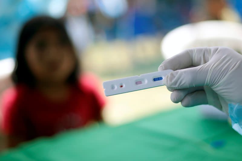 A member of Brazilian Armed Forces medical team takes COVID-19 test from a child from the indigenous Yanomami ethnic group, amid the spread of the coronavirus disease (COVID-19), at the Waikas region in the municipality of Auaris