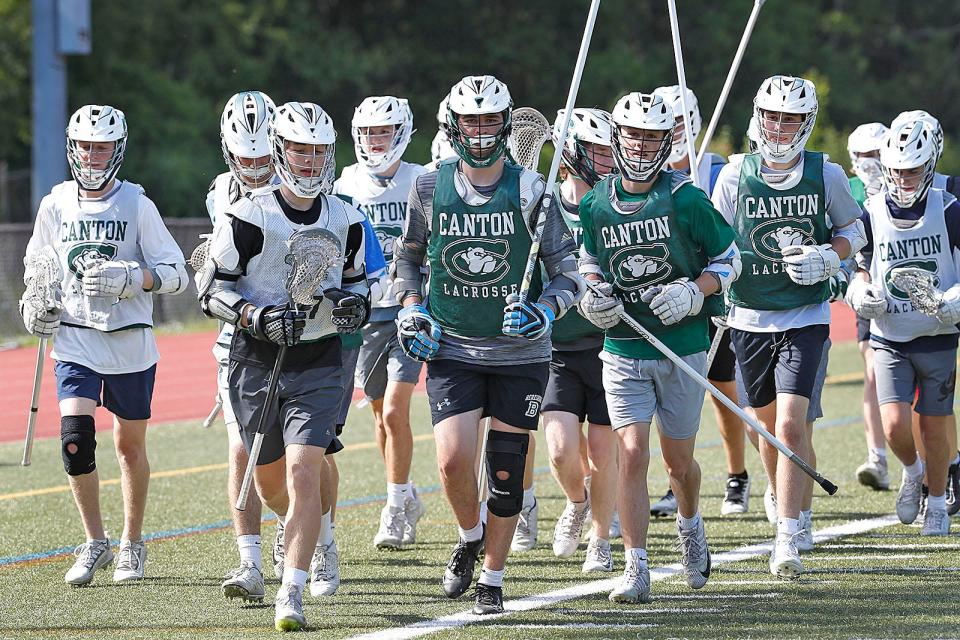 Sean Connolly leads the Canton High boys lacrosse in running laps during practice on Wednesday, May 25, 2022.