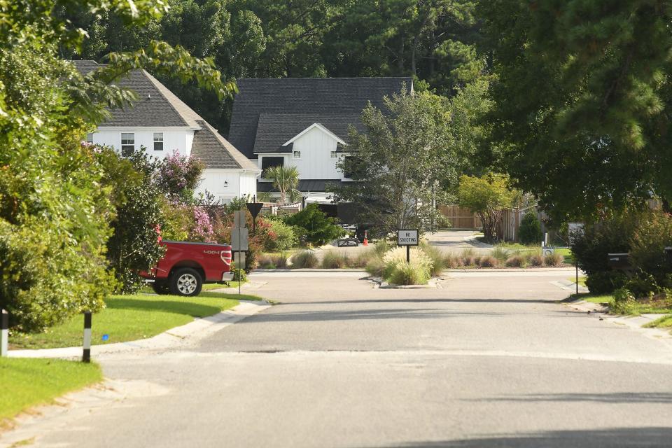 The corner of Stoneybrook Road and Bedrock Court in Ogden Wednesday Aug. 10, 2022. Ogden residents have asked New Hanover County to step in to improve the condition of an "orphan road" in their neighborhood. The residents along Stoneybrook Road will pay the county to bring the road's condition up to state standards, so it can be taken over by NCDOT. Orphan roads occur when developers don't maintain roads built within their communities. KEN BLEVINS/STARNEWS