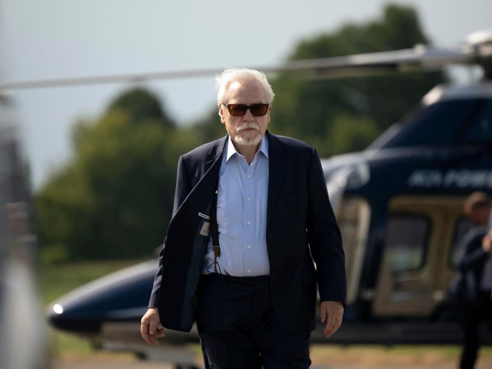 An image from the HBO show "Succession" of the character Logan Roy, with a helicopter in the background.