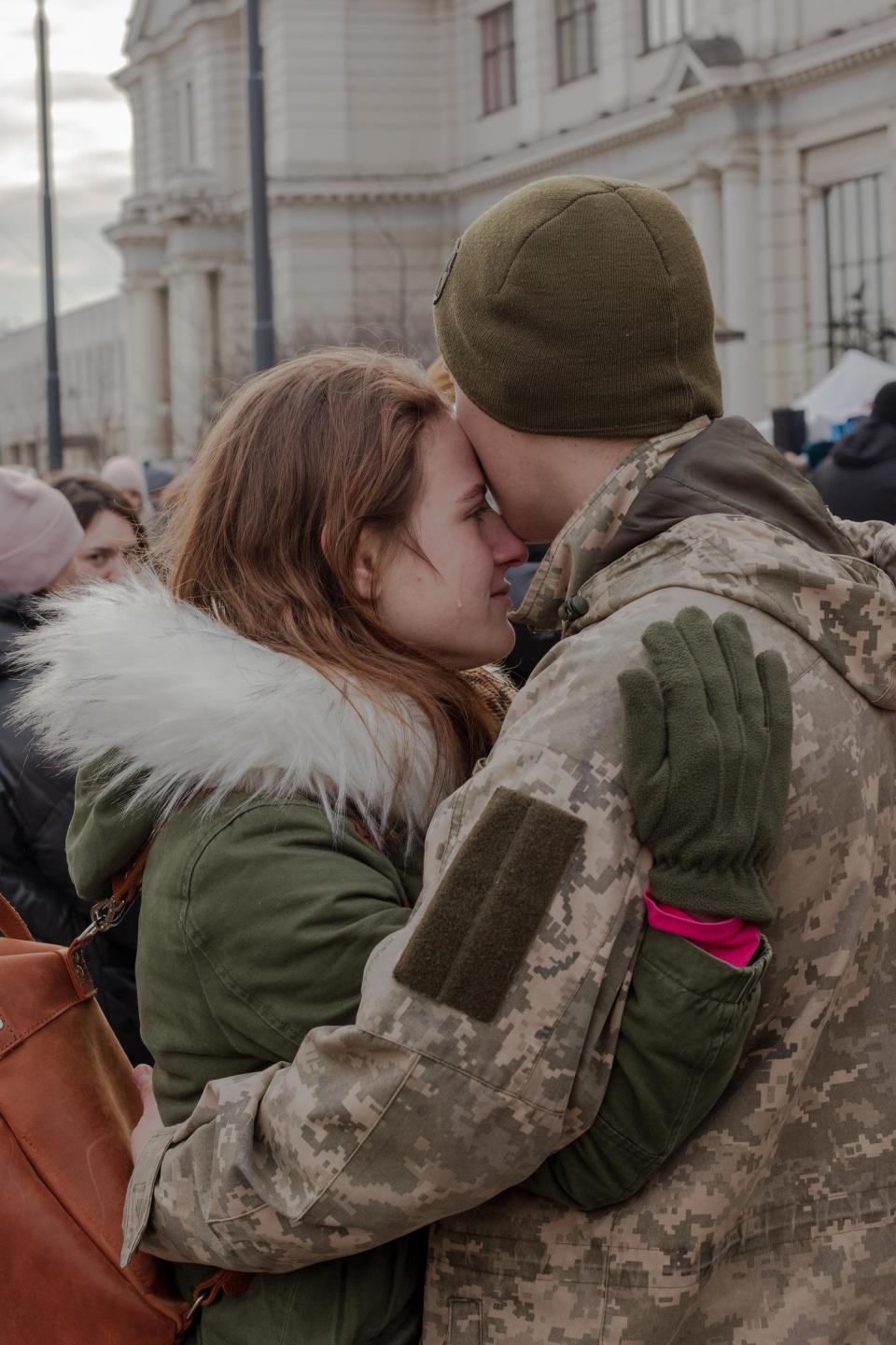 Soldiers say emotional goodbyes to their partners at the Lviv train station before heading to the front lines on March 8.<span class="copyright">Natalie Keyssar for TIME</span>