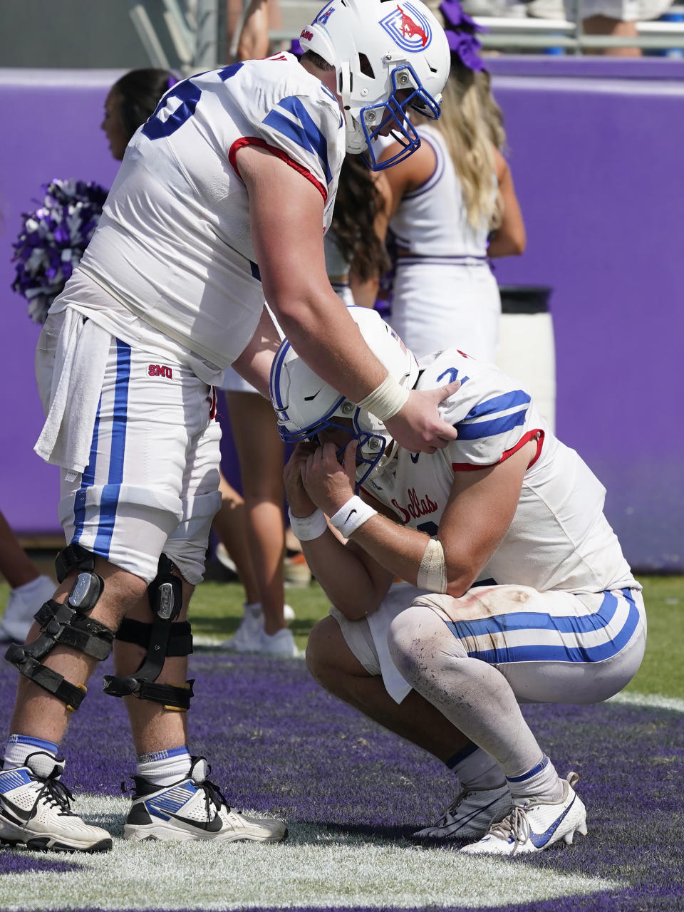 SMU quarterback Preston Stone (2) is comforted by teammate lineman Branson Hickman after an NCAA college football game against TCU, Saturday, Sept. 23, 2023, in Fort Worth, Texas. (AP Photo/LM Otero)