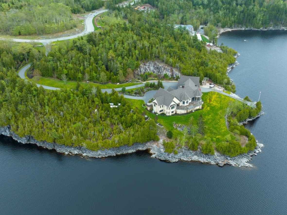 This house on a point overlooking the Kennebecasis River sold in 2014 for $5.15 million.  However, it's assessed for property taxes for less than half that amount.  (Roger Cosman/CBC News - image credit)