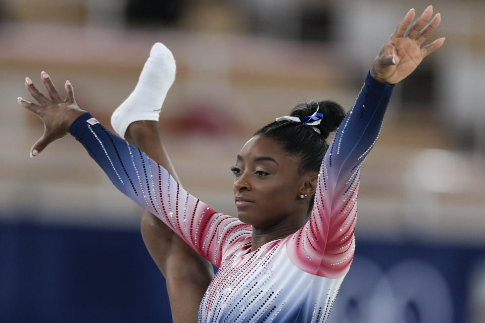 Simone Biles, of the United States, smiles during the warm up prior to the artistic gymnastics balance beam final at the 2020 Summer Olympics, Tuesday, Aug. 3, 2021, in Tokyo, Japan. (AP Photo/Natacha Pisarenko)