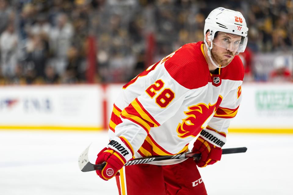 Oct 14, 2023; Pittsburgh, Pennsylvania, USA; Calgary Flames center Elias Lindholm (28) lines up for a face-off against the Pittsburgh Penguins during the second period at PPG Paints Arena.