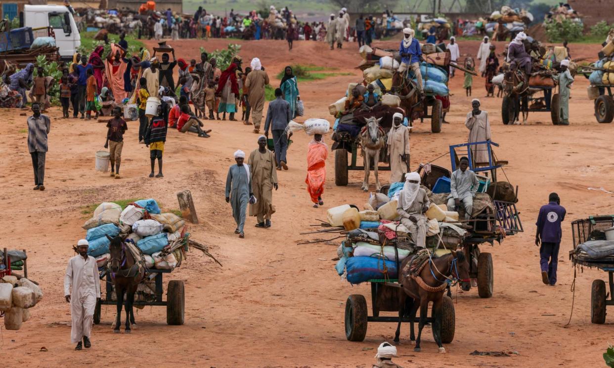 <span>People crossing the border into Chad last year after fleeing the fighting in Darfur.</span><span>Photograph: Zohra Bensemra/Reuters</span>