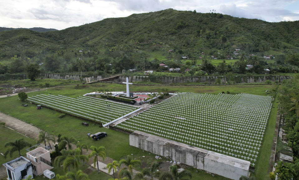 Rows of crosses sit at the mass grave site at the Holy Cross Memorial Garden for victims of super Typhoon Haiyan in Tacloban, central Philippines on Sunday Oct. 23, 2022. About 40% of the population of Tacloban was relocated to safer areas after super Typhoon Haiyan wiped out most of the villages, killing thousands when it hit central Philippines in 2013. (AP Photo/Aaron Favila)