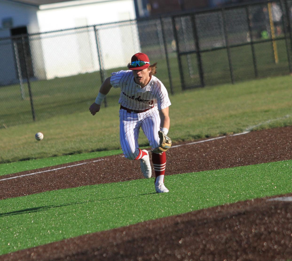 Newark's Seth Fish charges a bouncer during the host Wildcats' 6-4 loss in eight innings to visiting Big Walnut in their season opener at Joe Neff Field on Monday, March 25, 2024.