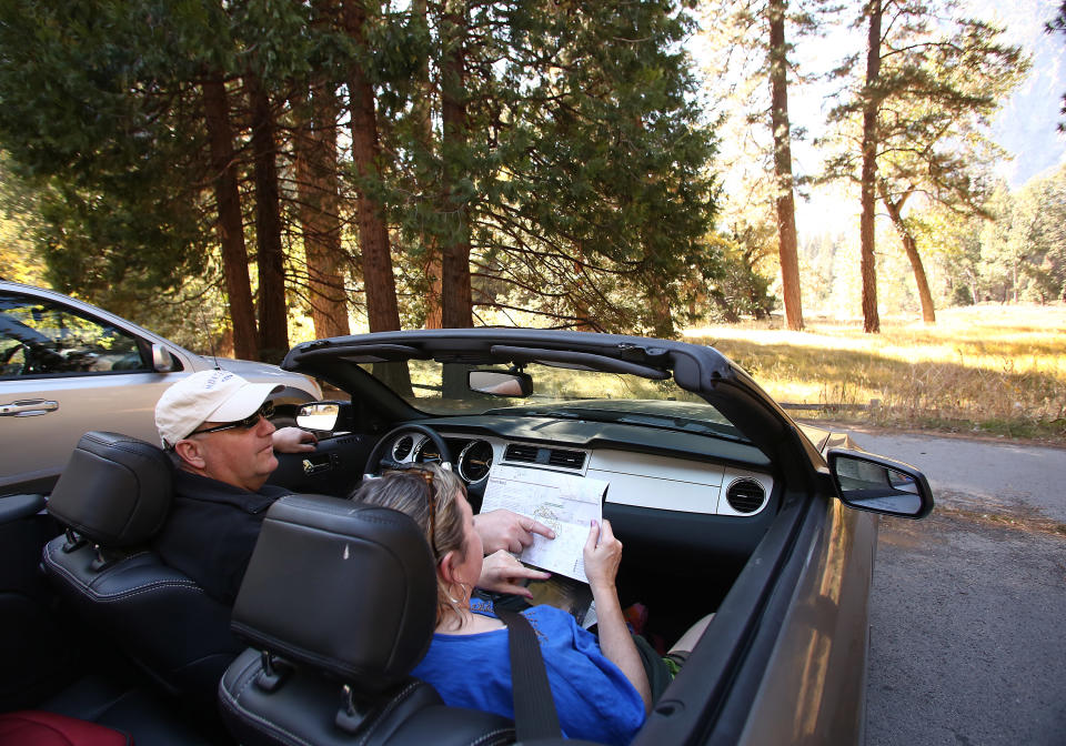 Clint and Deanna Fisher, from Iowa, look at directions while visiting Yosemite National Park, Calif., Thursday, Oct. 17, 2013. The park reopened Wednesday night with the end of the 16-day partial government shutdown. (AP Photo/Gary Kazanjian)