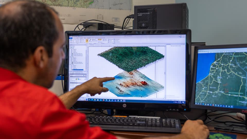 Juan Fernandez-Diaz examines maps on his computer. - Jonathan Burke/University of Houston