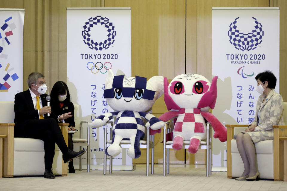 International Olympic Committee President Thomas Bach, left, talks with Tokyo Governor Yuriko Koike, right, during their meeting in Tokyo, Monday, Nov. 16, 2020. IOC President Bach is beginning a visit to Tokyo to convince politicians and the Japanese public that the postponed Olympics will open in just over eight months.(AP Photo/Koji Sasahara)