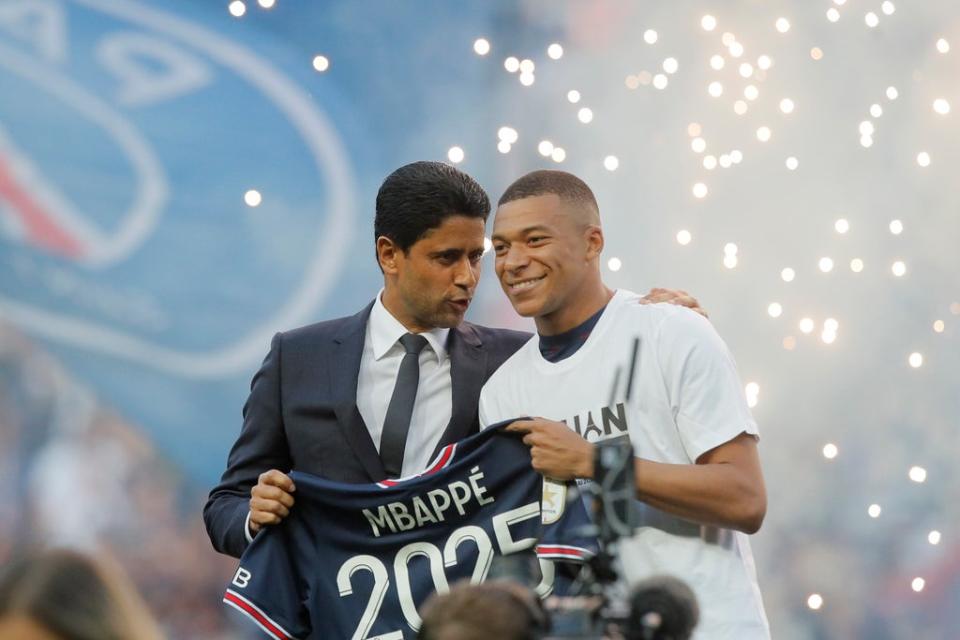 PSG president Nasser Al-Khelaifi celebrates Kylian Mbappe’s new contract at the Parc des Princes stadium on Saturday  (AP)