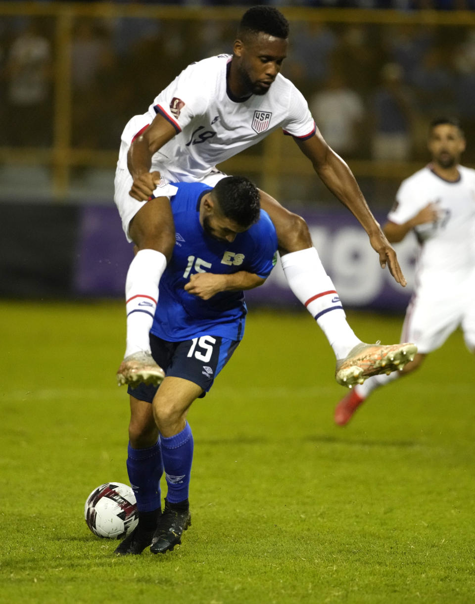 United States' Jordan Pefok, top, and El Salvador's Alex Roldan, fight for the ball during a qualifying soccer match for the FIFA World Cup Qatar 2022 at Cuscatlan stadium in San Salvador, El Salvador, Thursday, Sept. 2, 2021. (AP Photo/Moises Castillo)