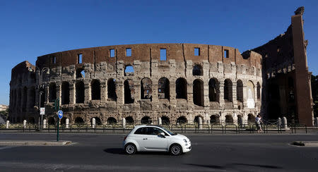 FILE PHOTO: A Fiat 500 is seen in front of the ancient Colosseum in Rome, Italy, May 28, 2017. Picture taken on May 28, 2017. REUTERS/Stefano Rellandini/File Photo