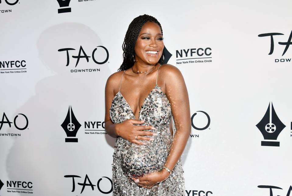 Keke Palmer holds her baby bump on the red carpet at the New York Film Critics Circle Awards.