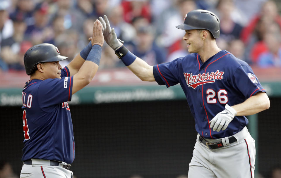 Minnesota Twins' Max Kepler, right, is congratulated by Willians Astudillo after Kepler hit a two-run home run off Cleveland Indians starting pitcher Trevor Bauer during the third inning of a baseball game, Thursday, June 6, 2019, in Cleveland. (AP Photo/Tony Dejak)