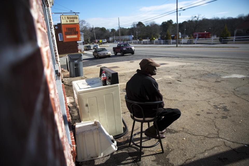 Kyle McArthur, 76, sits outside a thrift store along the Main Street business district in Lula, Ga., in Hall County, where he's lived his whole life, Thursday, Jan. 12, 2017. The railroad town has 2,800 residents and no stoplight in the central business district. (AP Photo/David Goldman)