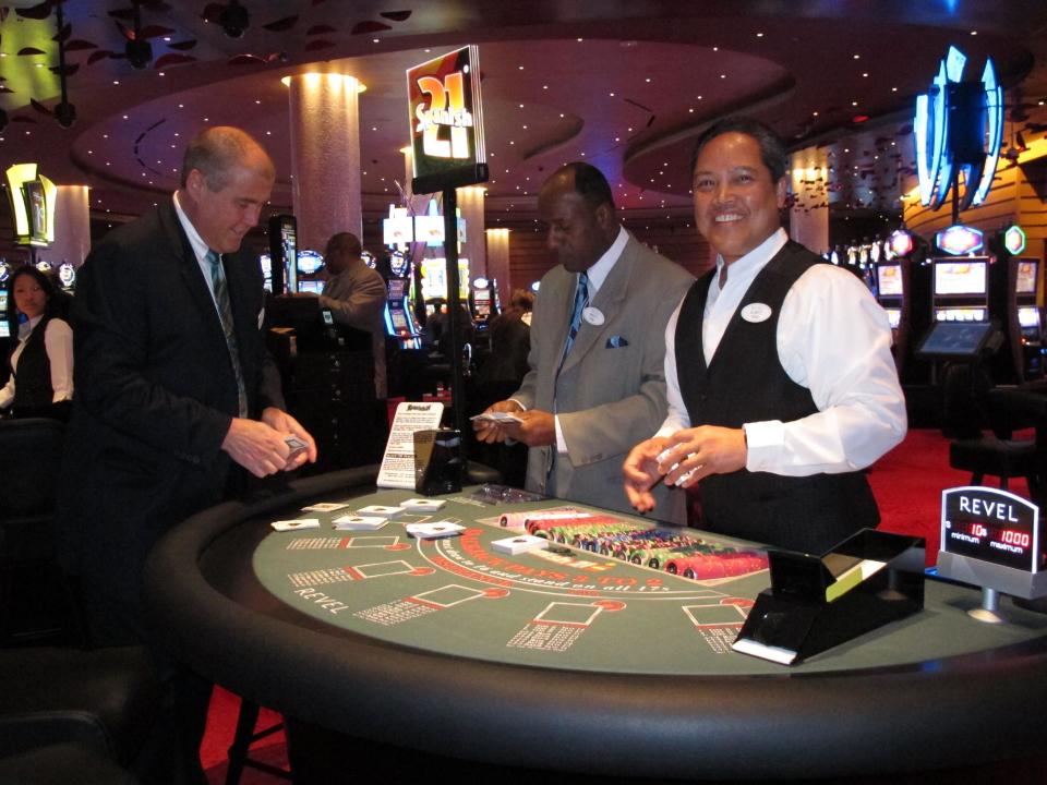 Dealer Elbert Taclan, right, prepares a card game moments after the $2.4 billion Revel casino resort opened in Atlantic City, N.J. on April 2, 2012. John Koryto, left, was watching him prepare for the first customers to arrive at the table. Three major unions including the Teamsters and the United Auto Workers announced a drive on April 30, 2012 to fully unionize the new casino, including dealers. (AP Photo/Wayne Parry)