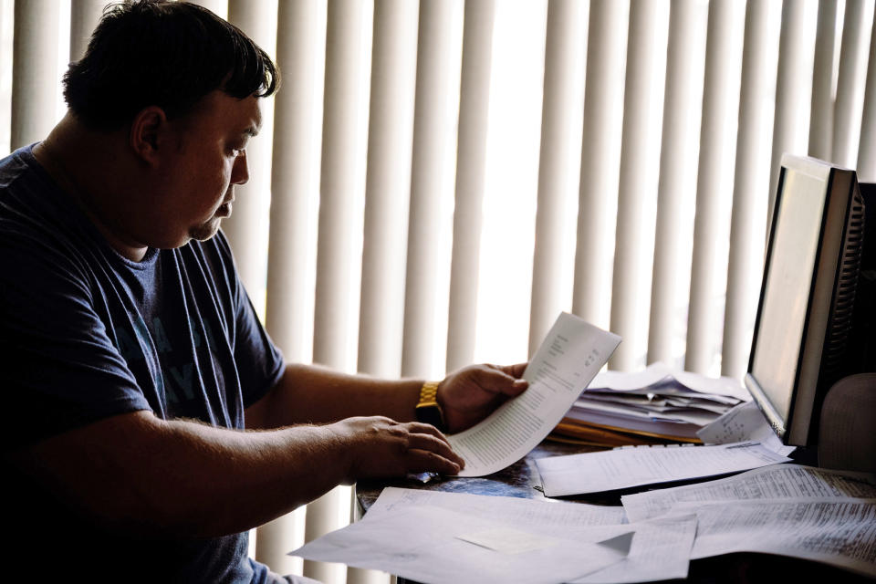 Image: Robert Jones looks over documents relating to his son's arrests. (Bob Croslin / for NBC News)