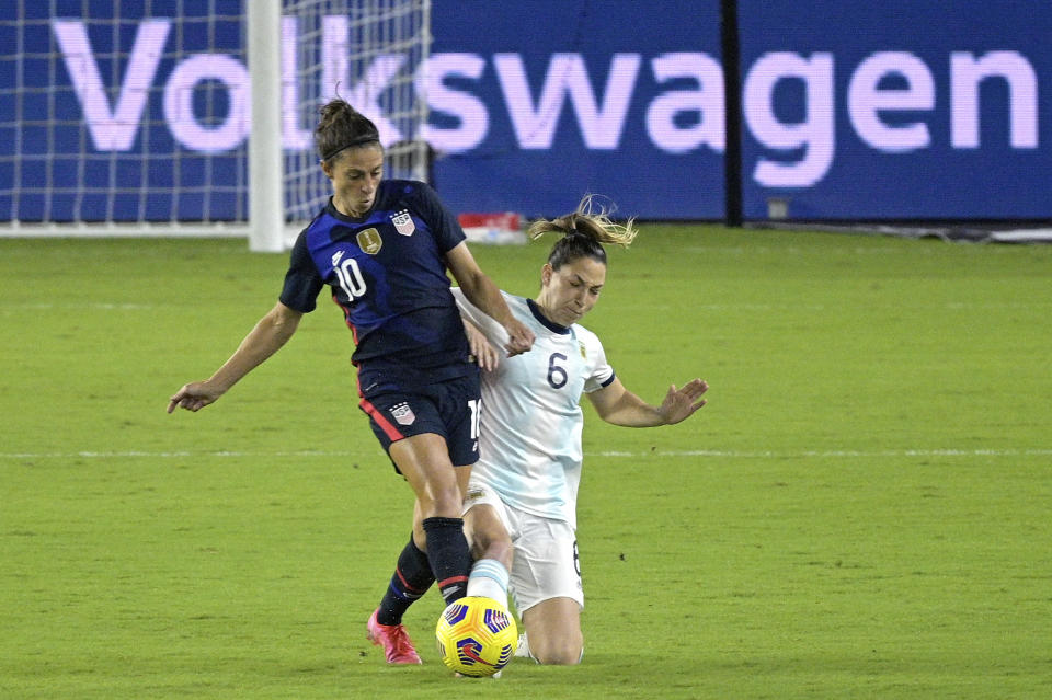 United States forward Carli Lloyd (10) and Argentina defender Aldana Cometti (6) compete for a ball during the first half of a SheBelieves Cup women's soccer match, Wednesday, Feb. 24, 2021, in Orlando, Fla. (AP Photo/Phelan M. Ebenhack)