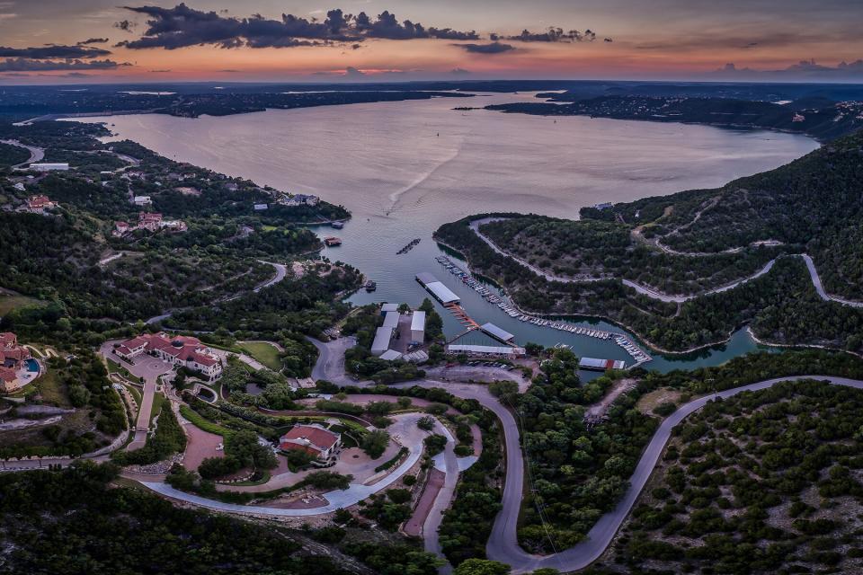 Aerial photo over a marina on Lake Travis in Austin, Texas during sunset.