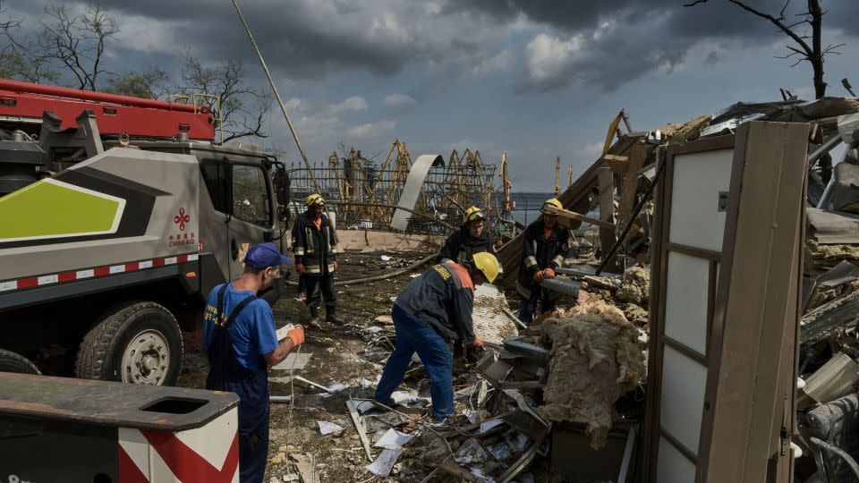 Emergency service personnel clear a destroyed building near the Odesa Port after a Russian attack on Thursday, July 20. Russian forces have pounded Ukraine's southern cities -- including the port city of Odesa -- with drones and missiles, damaging some of the country's critical grain export infrastructure. - Libkos/AP
