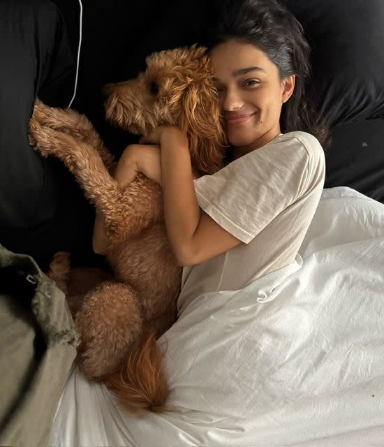 a person lying on a bed with a stuffed animal