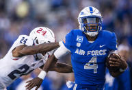 Air Force quarterback Haaziq Daniels (4) dodges Florida Atlantic cornerback Zyon Gilbert (24) as he runs in for a touchdown during an NCAA college football game at Air Force Academy, Colo., on Saturday, Sept. 25, 2021. (Chancey Bush/The Gazette via AP)