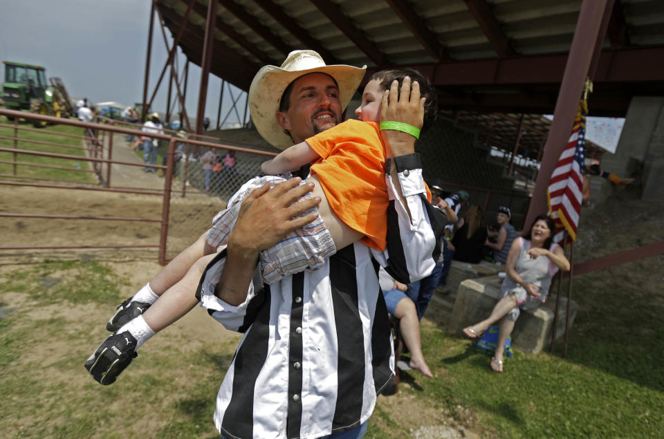 Inmate Joseph Ward plays with his nephew Eric Young, 3, who he has not seen since he was an infant, before the start of the Angola Prison Rodeo in Angola, La., Saturday, April 26, 2014. Louisiana’s most violent criminals, many serving life sentences for murder, are the stars of the Angola Prison Rodeo, the nation’s longest-running prison rodeo that this year celebrates 50 years. The event has grown from a small “fun” event for prisoners into big business, with proceeds going into the Louisiana State Penitentiary Inmate Welfare Fund for inmate education and recreational supplies. (AP Photo/Gerald Herbert)