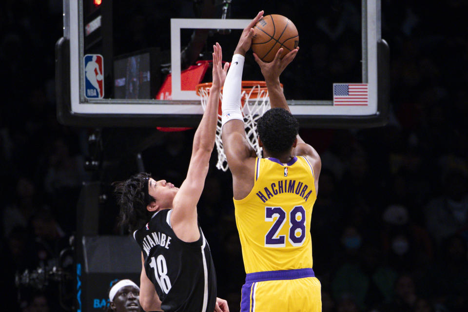 Los Angeles Lakers forward Rui Hachimura (28) shoots over Brooklyn Nets forward Yuta Watanabe (18) during the first half of an NBA basketball game Monday, Jan. 30, 2023, in New York. (AP Photo/Corey Sipkin)