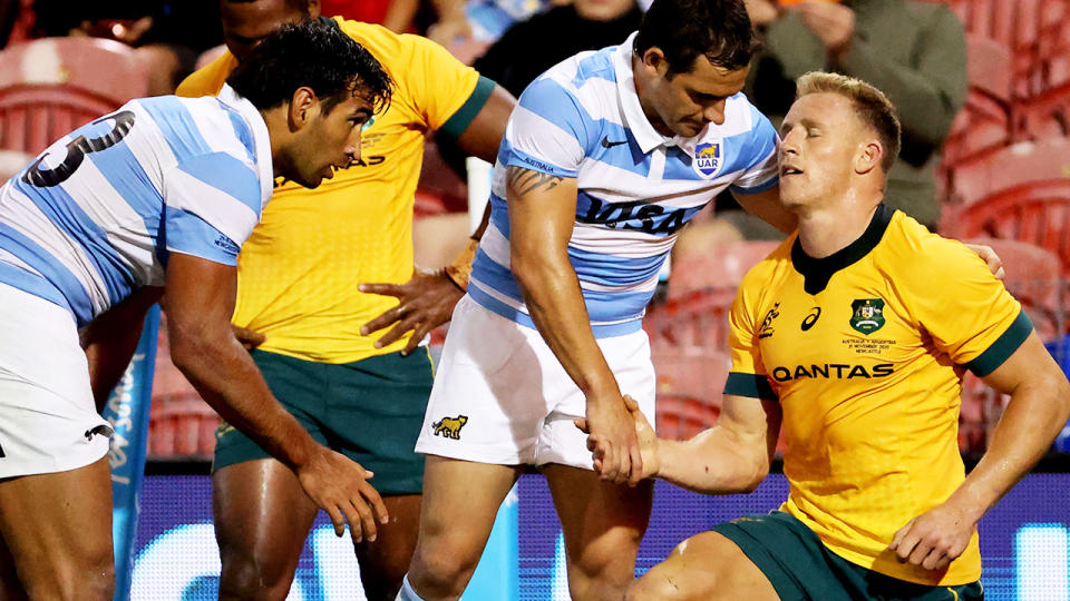 Nicolas Sanchez shakes hands with Reece Hodge after the Wallabies' clash with Argentina. (Photo by DAVID GRAY/AFP via Getty Images)