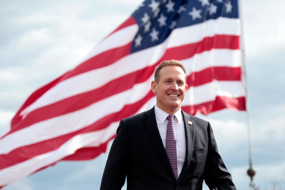 Republican candidate for U.S. Senate Ted Budd, of North Carolina, smiles as he takes the stage before former President Donald Trump speaks at a rally Saturday, April 9, 2022, in Selma, N.C. (AP Photo/Chris Seward)