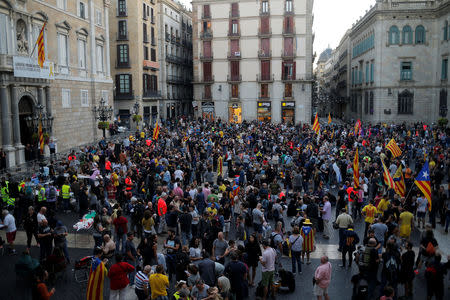 People stage a sit-in during an occupation of the Sant Jaume square, as a part of events planned to mark the first anniversary of the banned independence referendum held in the region on October 1, 2017, in front of the Catalan regional government headquarters in Barcelona, Spain, September 29, 2018. REUTERS/Jon Nazca