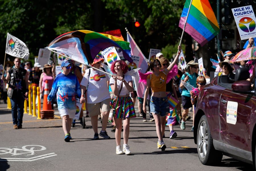 Participants march in the Pride parade through the streets of downtown Denver, Sunday, June 25, 2023. (AP Photo/David Zalubowski)