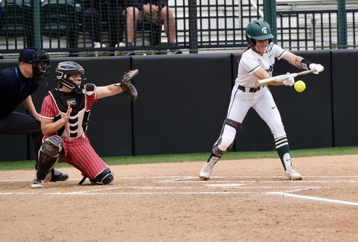 Michigan State sophomore outfielder Sydney Doloszycki (19) lays down a sacrifice bunt against Rutgers on Sunday, April 28, 2024 at Secchia Stadium. MSU beat the Scarlet Knights 4-1 on Senior Day.