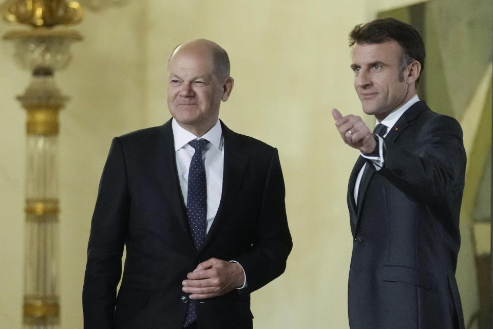 French President Emmanuel Macron, right, welcomes German Chancellor Olaf Scholz before their meeting with Ukraine's President Volodymyr Zelenskyy at the Elysee Palace in Paris, France, Wednesday, Feb. 8, 2023. Western support has been key to Kyiv's surprisingly stiff defense, and the two sides are engaged in grinding battles. (AP Photo/Thibault Camus)