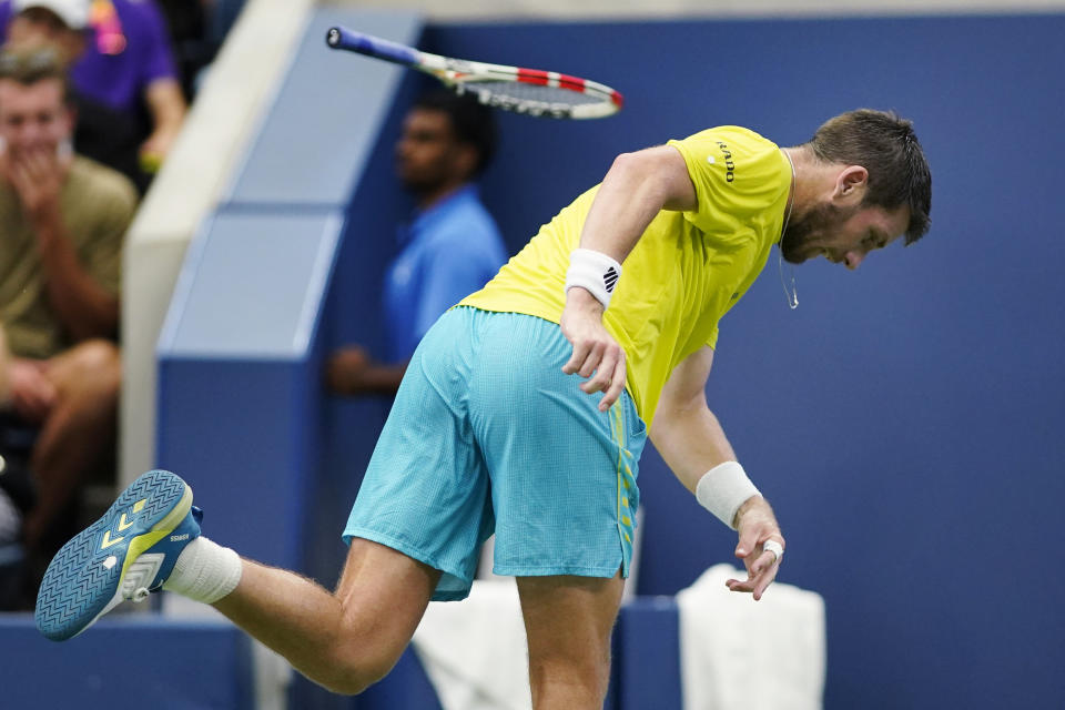 Cameron Norrie, of Great Britain, throws his racket during his match against Andrey Rublev, of Russia, during the fourth round of the U.S. Open tennis championships, Monday, Sept. 5, 2022, in New York. (AP Photo/Eduardo Munoz Alvarez)