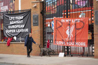 Banners are seen outside Liverpool's Anfield Stadium after the collapse of English involvement in the proposed European Super League, Liverpool, England, Wednesday, April 21, 2021. Liverpool owner John W Henry has apologised to the club's supporters for the "disruption" caused by the proposed European Super League (ESL). (AP Photo/Jon Super)