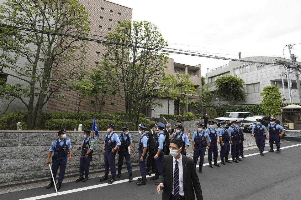 Police officers stand guard in front of the residence of Japan's former Prime Minister Shinzo Abe Saturday, July 9, 2022, in Tokyo. The body of Japan’s former Prime Minister Shinzo Abe was returned to Tokyo on Saturday after he was fatally shot during a campaign speech in western Japan a day earlier.(AP Photo/Eugene Hoshiko)