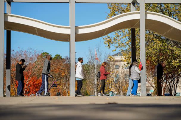 PHOTO: Voters line up to cast their ballots during early voting in the runoff U.S. Senate election between Democratic Senator Raphael Warnock and his Republican challenger Herschel Walker, at a polling center in Columbus, Georgia, on Nov. 28, 2022.  (Cheney Orr/Reuters)