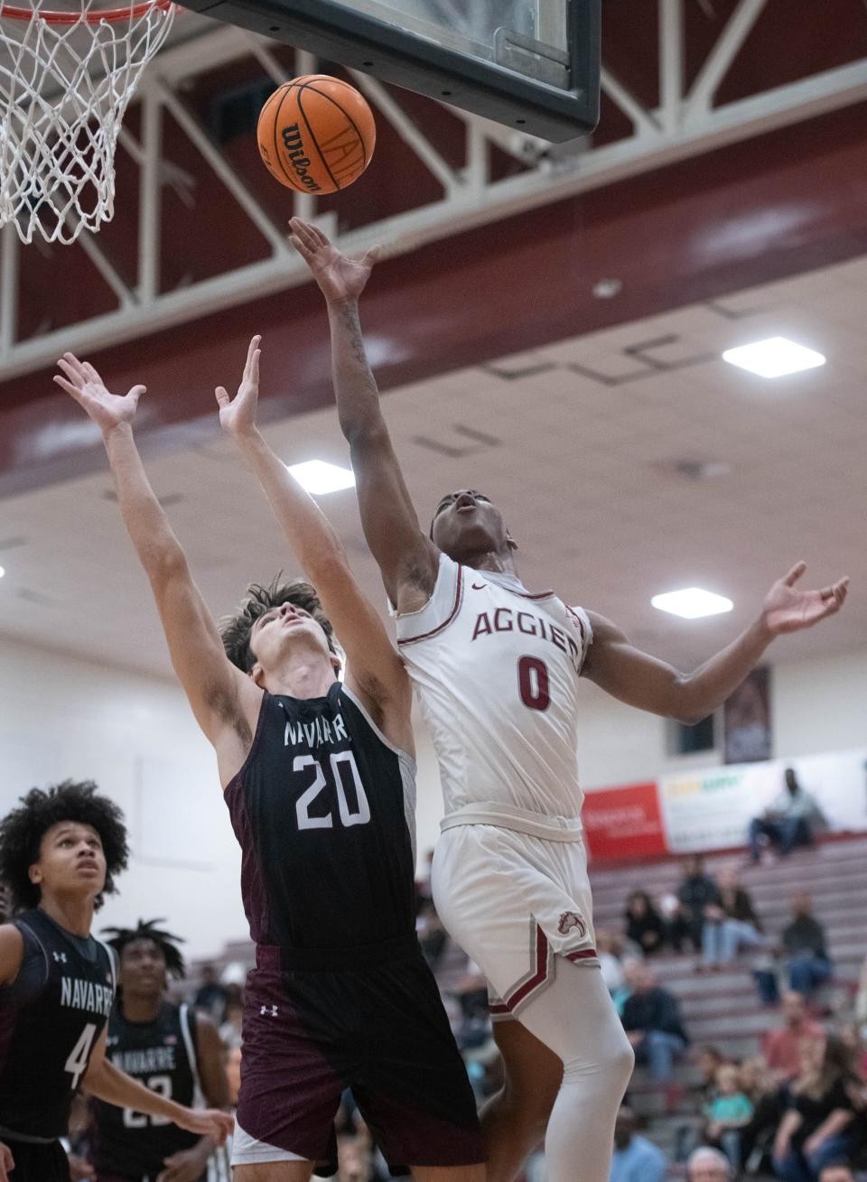 Deonne Williams Jr. (0) shoots during the Navarre vs Tate boys basketball game at Tate High School on Friday, Jan. 12, 2024.