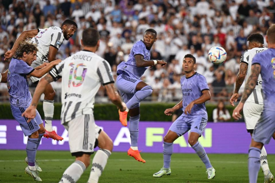 Real Madrid's Luka Modric, left, vies for the ball with Juventus' Gleison Bremer.