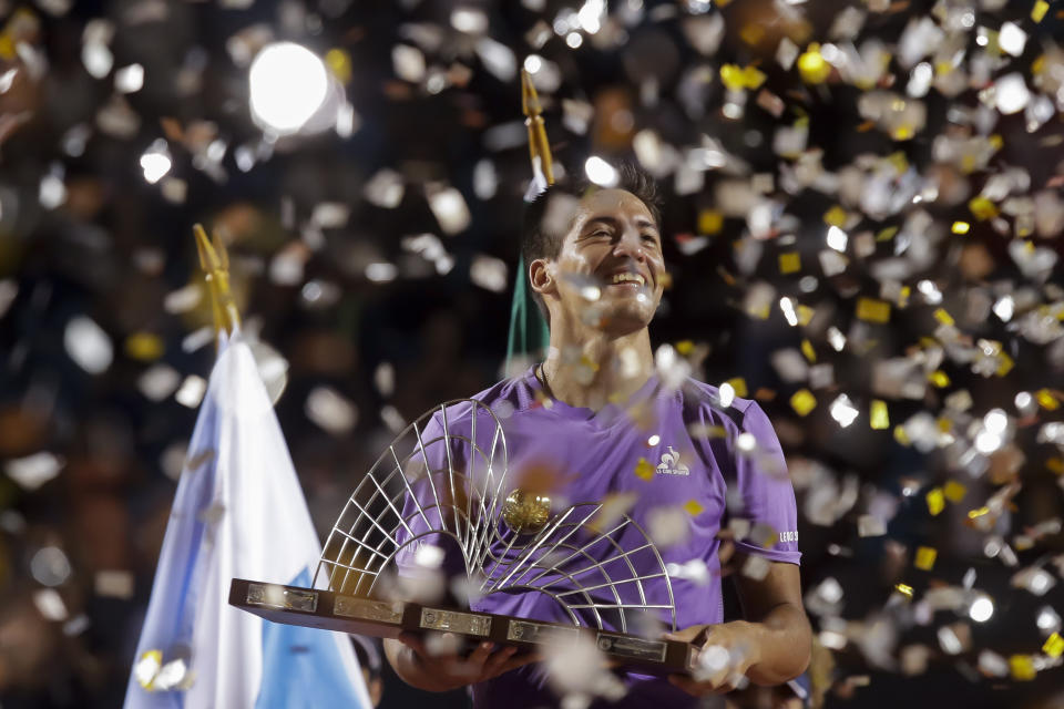 Sebastian Baez holds his trophy after defeating Mariano Navone, both of Argentina, during the final match of the Rio Open tennis tournament in Rio de Janeiro, Brazil, Sunday, Feb. 25, 2024. (AP Photo/Bruna Prado)