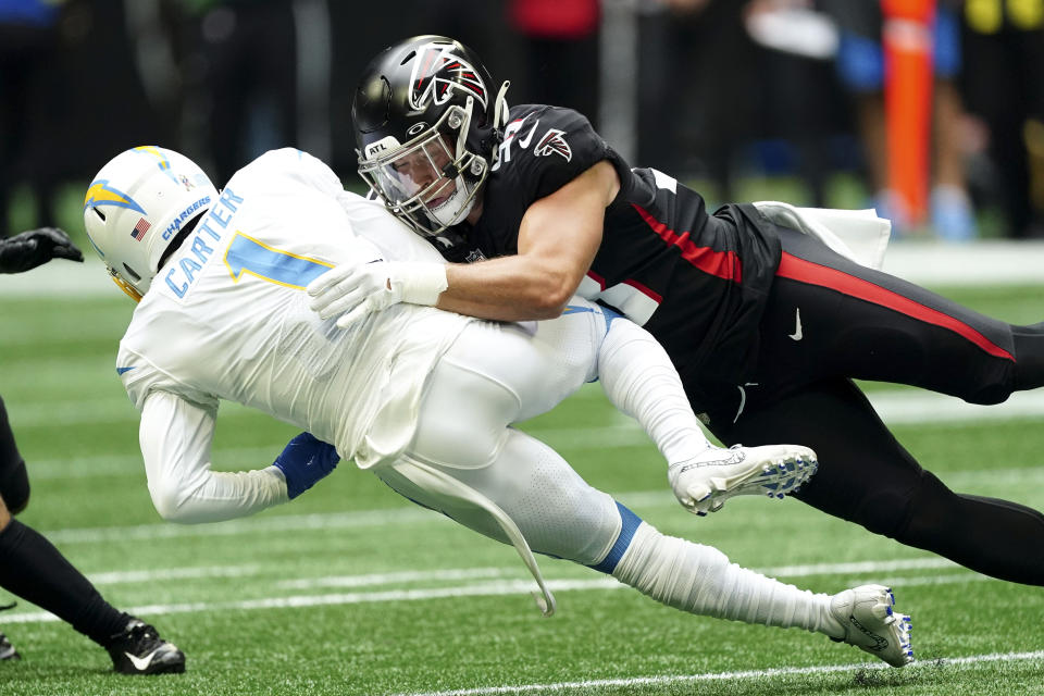 Los Angeles Chargers' DeAndre Carter (1) is tackled by Atlanta Falcons' Nick Kwiatkoski, right, while returning a punt during the first half of an NFL football game, Sunday, Nov. 6, 2022, in Atlanta. (AP Photo/John Bazemore)