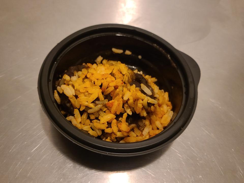 cup of beans and rice from taco bell on a silver counter