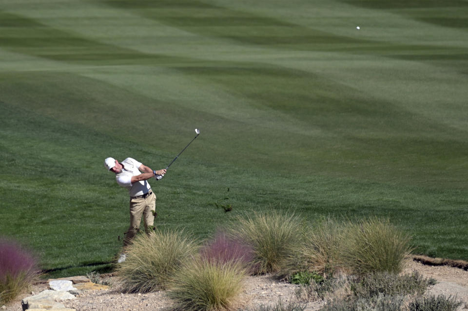 Rory McIlroy, of Northern Ireland, hits on the 17th hole during first round of the CJ Cup golf tournament Thursday, Oct. 14, 2021, in Las Vegas. (AP Photo/David Becker)