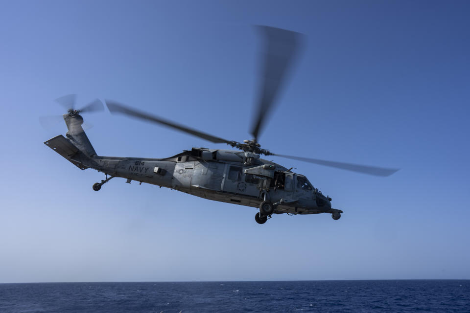 An HSC-7 helicopter flies toward the USS Dwight D. Eisenhower in the Red Sea on Wednesday, June 12, 2024. (AP Photo/Bernat Armangue)