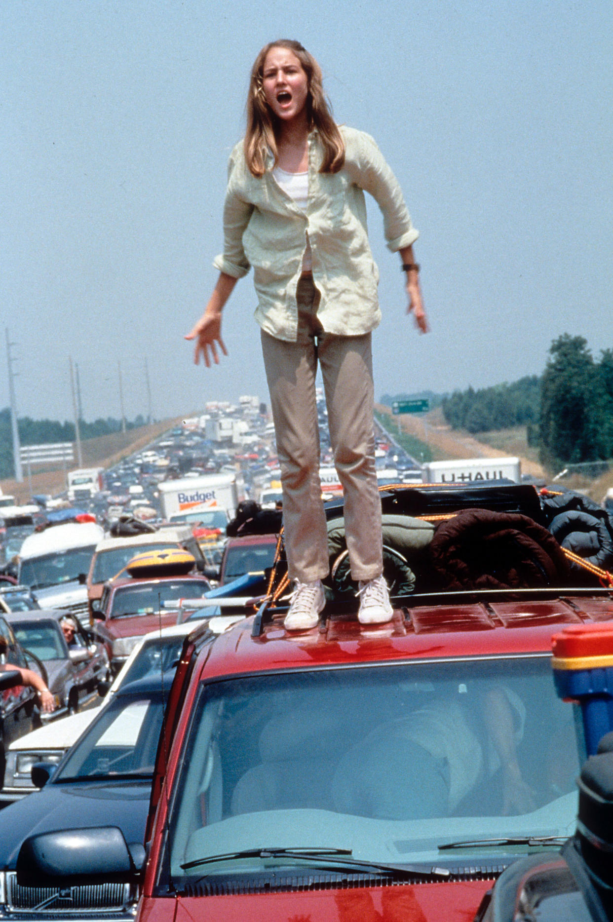 Leelee Sobieski standing on a roof of a car in a scene from the film 'Deep Impact', 1998. (Photo by Paramount Pictures/Getty Images)